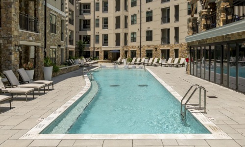a pool in a courtyard between buildings