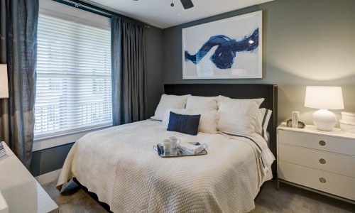 a bedroom with a fan and a bed
