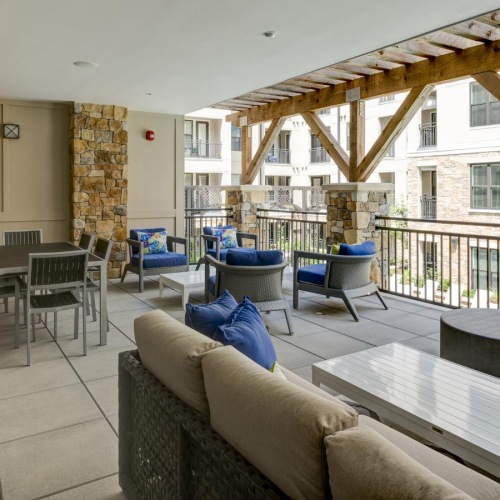 a lounge with tables, chairs and a tv