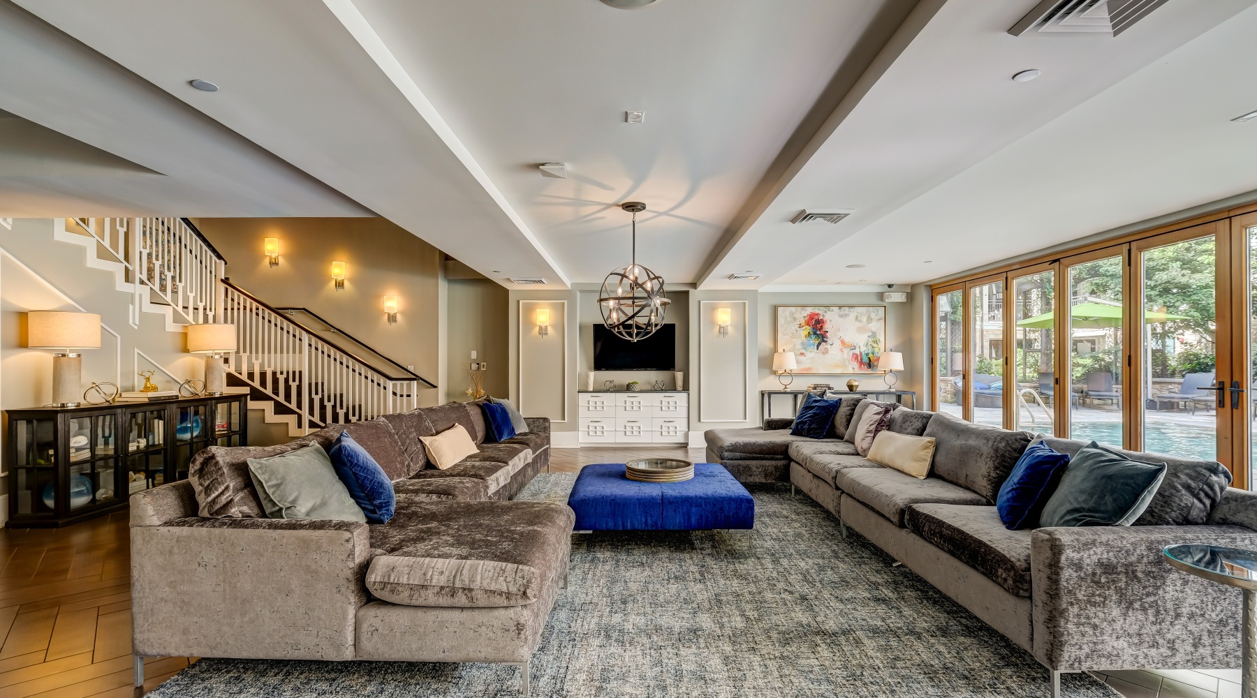 a clubroom with large couches, a table and a tv