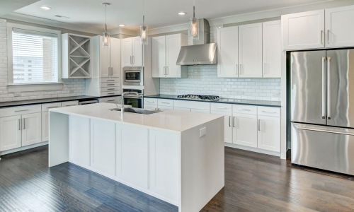a kitchen with white cabinets