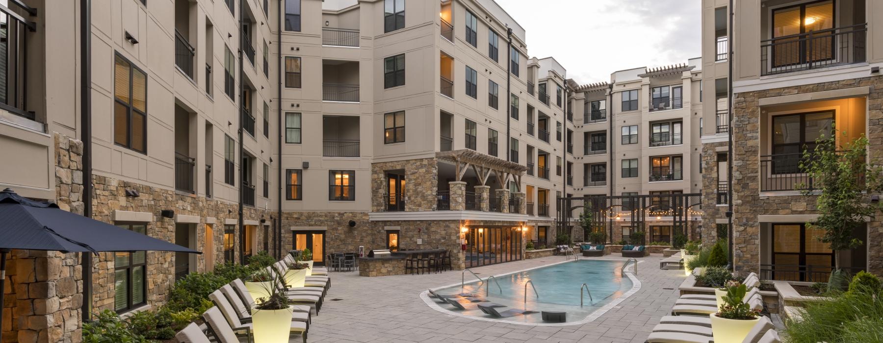 a pool in a courtyard between buildings