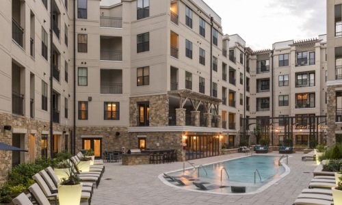 a pool in a courtyard between buildings